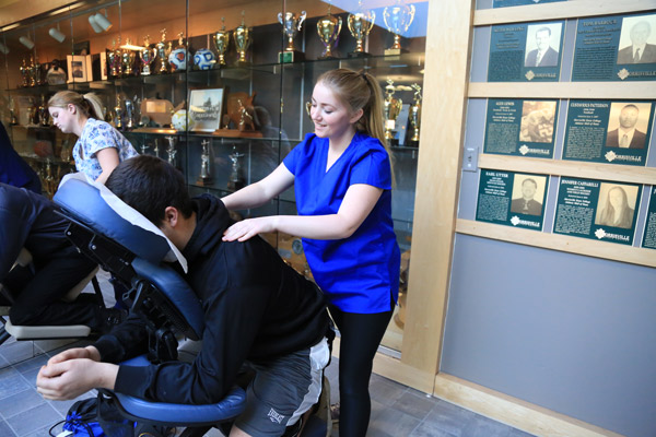 Massage therapy students practice on volunteers.