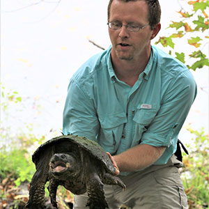 Eric Diefenbacher holds a turtle