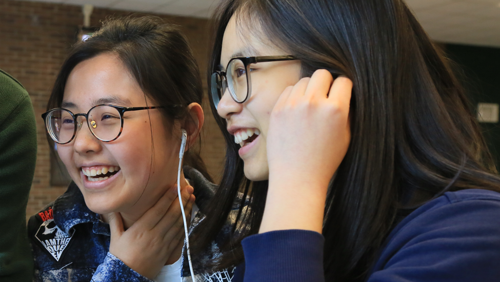 Two laughing international students