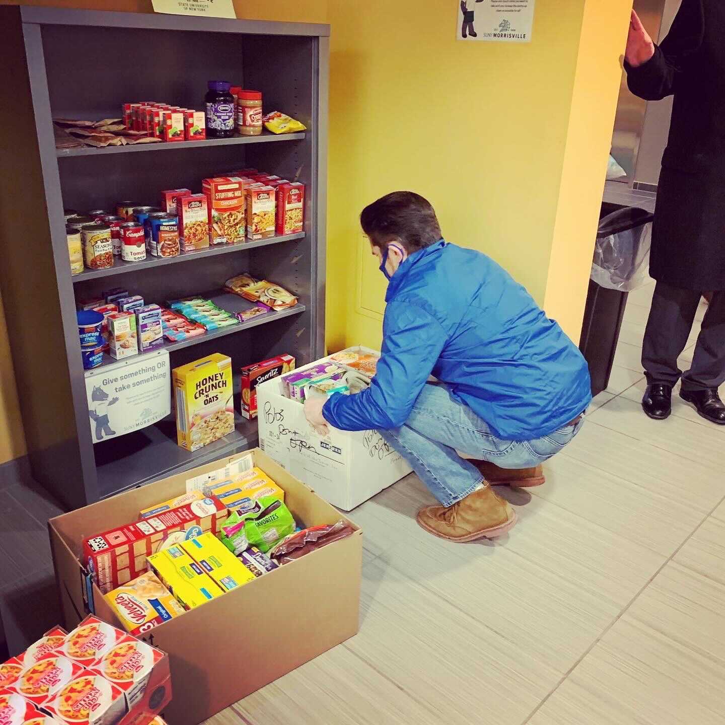State University of New York Chancellor Jim Malatras visits SUNY Morrisville’s campus food pantry and helps stock its shelves.