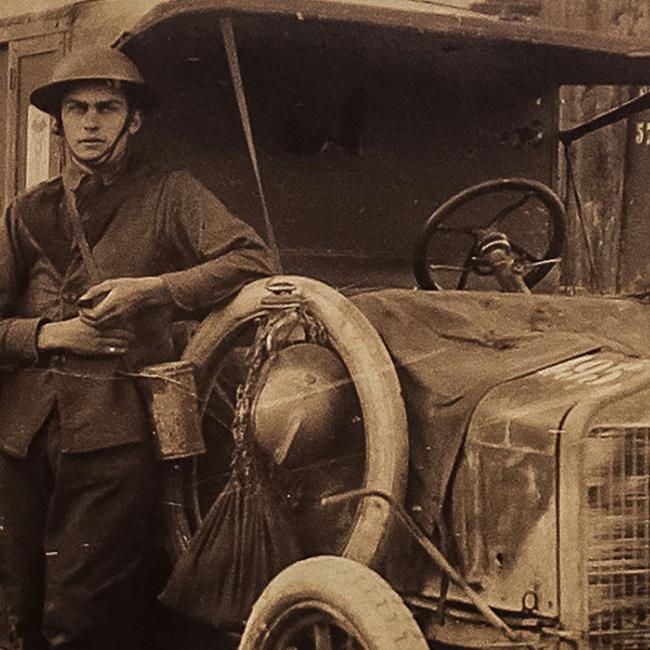 A photo from France. Leonard Cunningham (right) leans against the ambulance he drove during WWI.