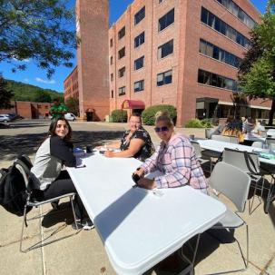 Norwich students hang out in front of Follett Hall.
